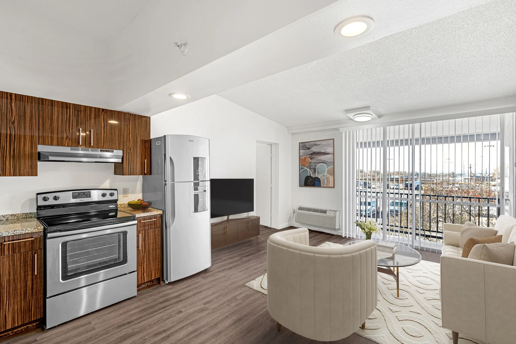 Furnished living room with vaulted ceiling, stainless appliances and balcony at ABQ Encore Apartments, Albuquerque